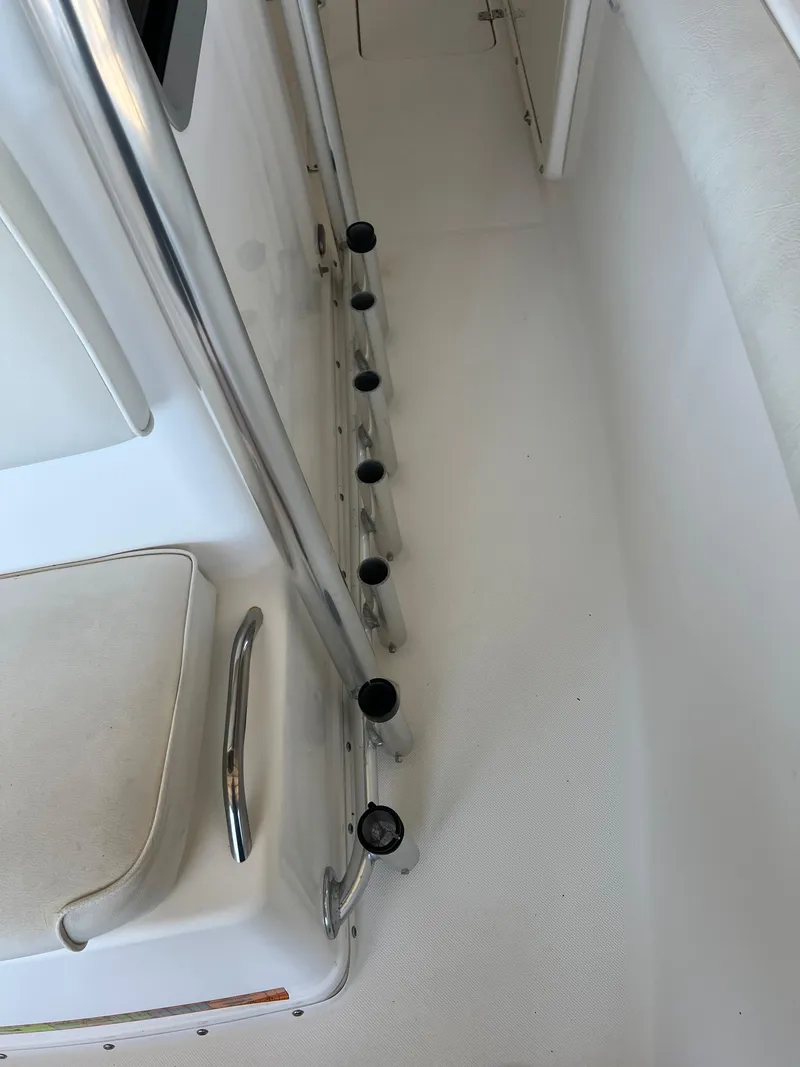 Slide: The Image of Interior view of a 2007 Century 2600 CC boat, featuring rod holders and seating. - 8