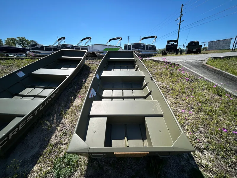 Slide: The Image of 2025 Crestliner CR1240 boat on grassy lot under clear blue sky. - 11