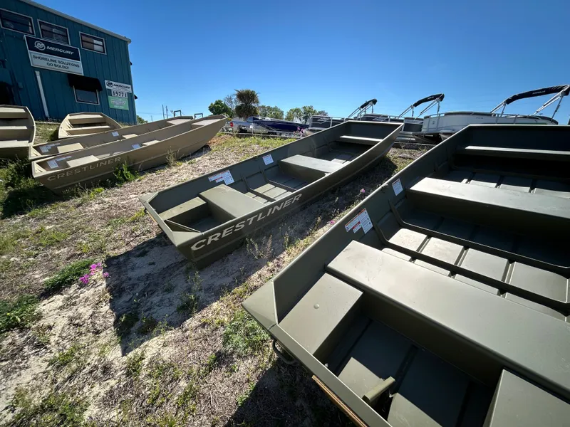 Slide: The Image of 2025 Crestliner CR1240 boats displayed outdoors under clear blue sky. - 12