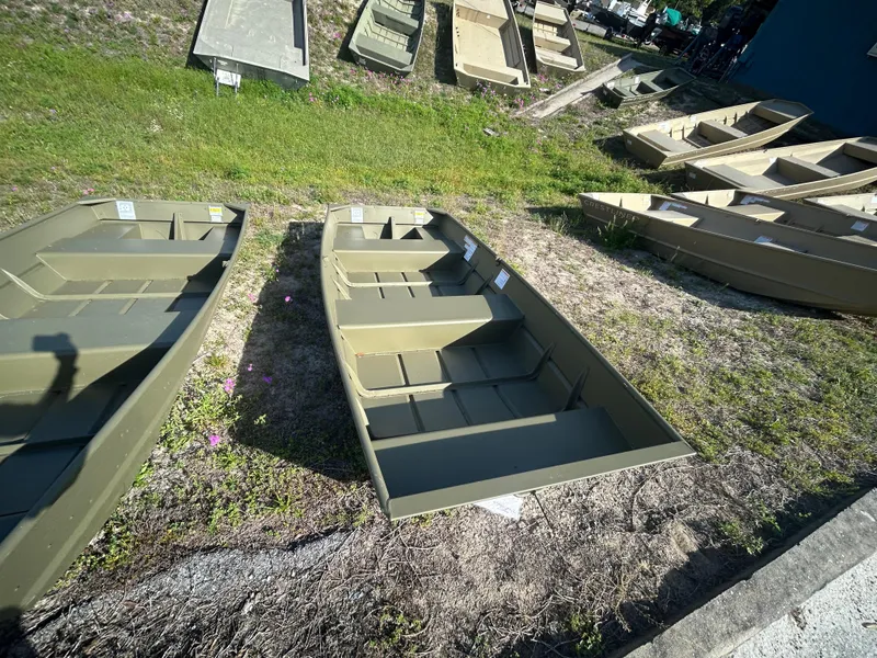 Slide: The Image of 2025 Crestliner CR1240 boats displayed outdoors on grass. - 2