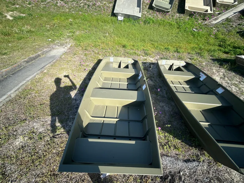 Slide: The Image of 2025 Crestliner CR1240 boats on grass, shadow of person taking photo. - 3