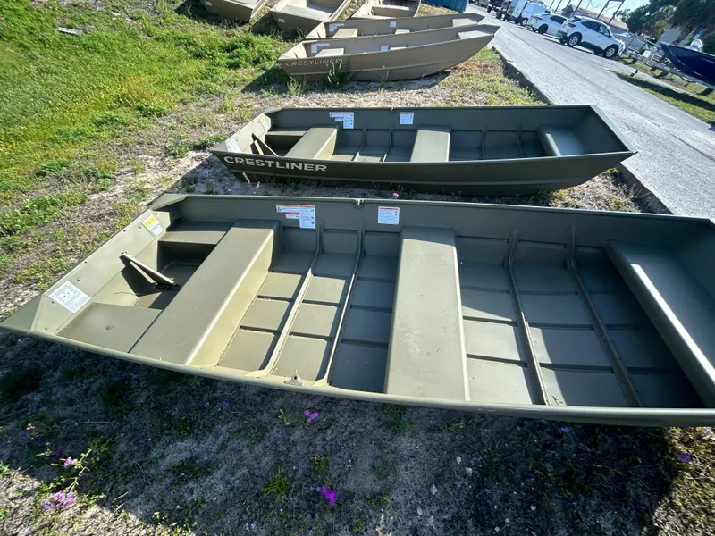 Slide: The Image of 2025 Crestliner CR1240 aluminum boats displayed outdoors on grass. - 5