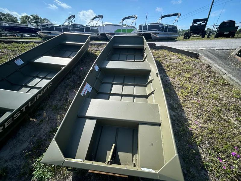 Slide: The Image of 2025 Crestliner CR1240 boat displayed outdoors on grassy area. - 7