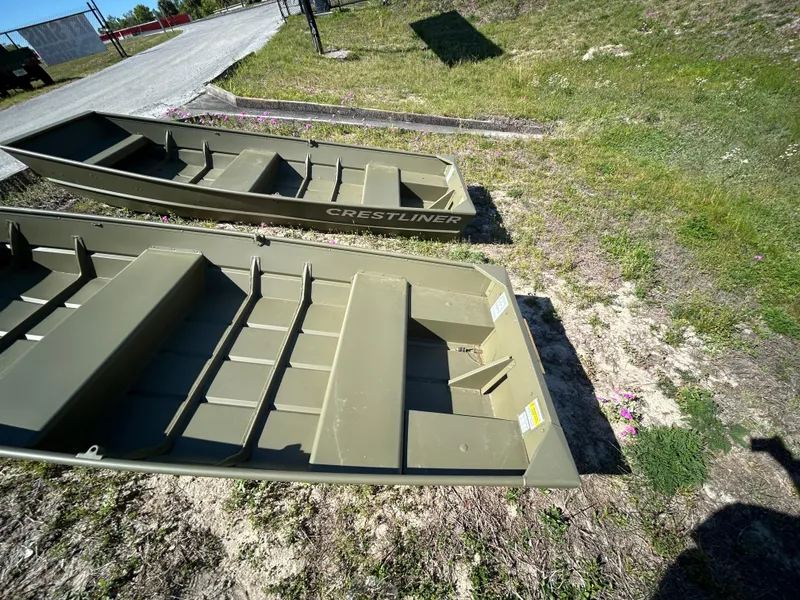 Slide: The Image of 2025 Crestliner CR1240 boats on grassy terrain, showcasing durable design and construction. - 9