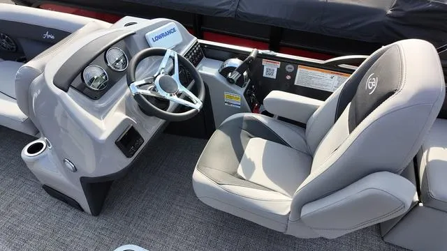 Slide: The Image of 2025 Barletta Aria A22CC boat cockpit with steering wheel and comfortable seating. - 14
