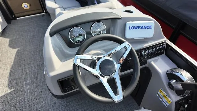 Slide: The Image of 2025 Barletta Aria A22CC boat dashboard with steering wheel and Lowrance display. - 15