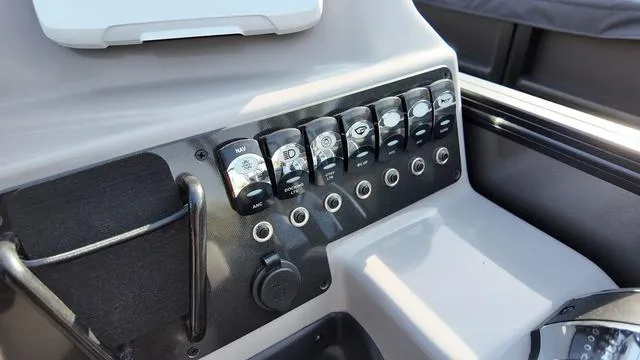 Slide: The Image of Control panel of 2025 Barletta Aria A22CC boat with labeled switches. - 16