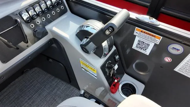 Slide: The Image of Control panel of 2025 Barletta Aria A22CC boat with throttle and switches. - 17