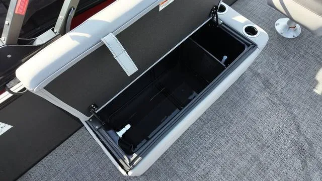 Slide: The Image of Open storage compartment on 2025 Barletta Aria A22CC boat with cup holders. - 20