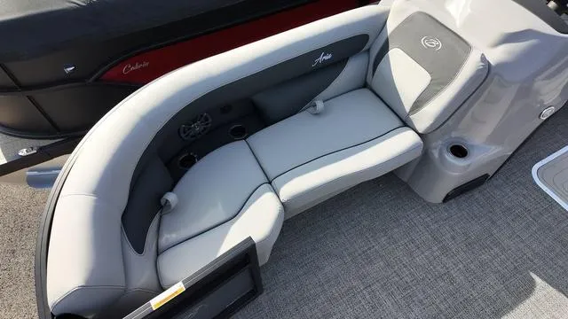Slide: The Image of 2025 Barletta Aria A22CC boat interior with gray seating and cup holders. - 8