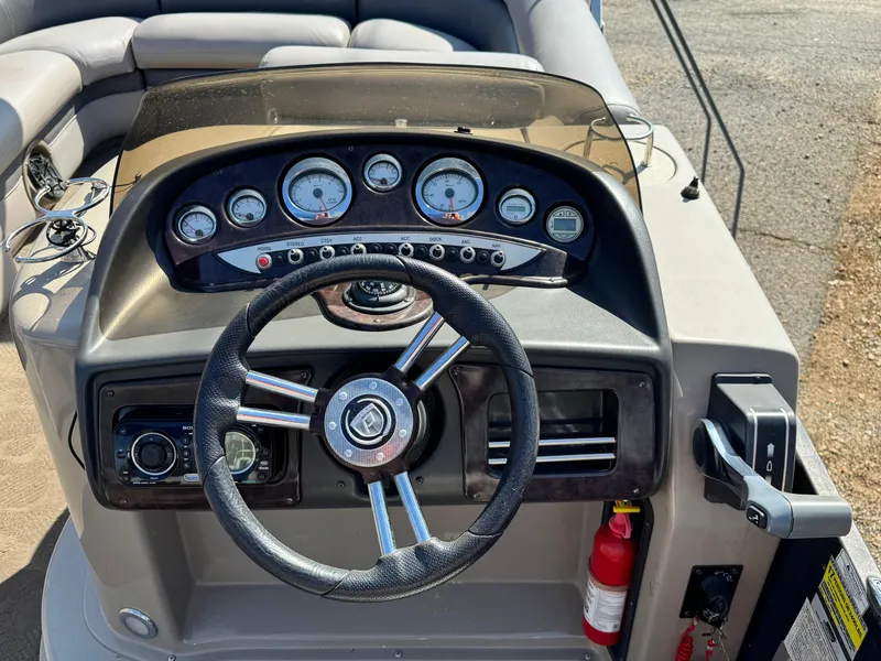 Slide: The Image of Steering console of 2010 Premier 235 Grand Majestic LTD boat with gauges and controls. - 10
