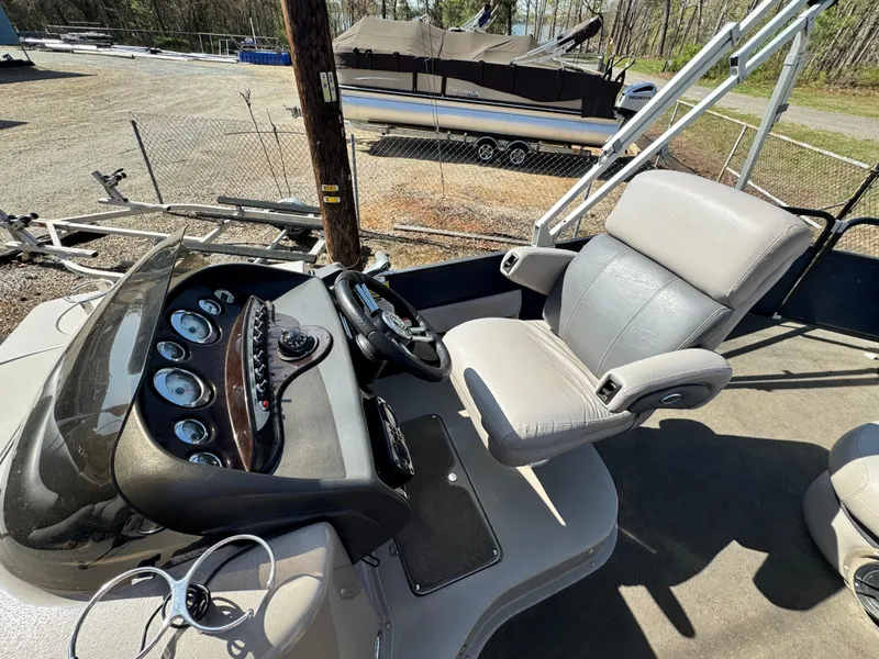 Slide: The Image of Captain's seat and dashboard of a 2010 Premier 235 Grand Majestic LTD boat. - 11