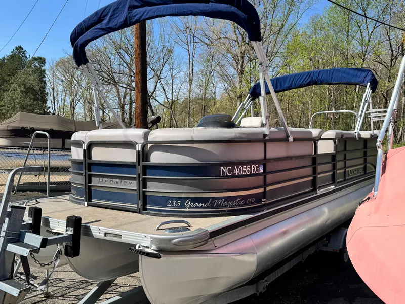 Slide: The Image of 2010 Premier 235 Grand Majestic LTD pontoon boat with blue canopy, docked outdoors. - 3