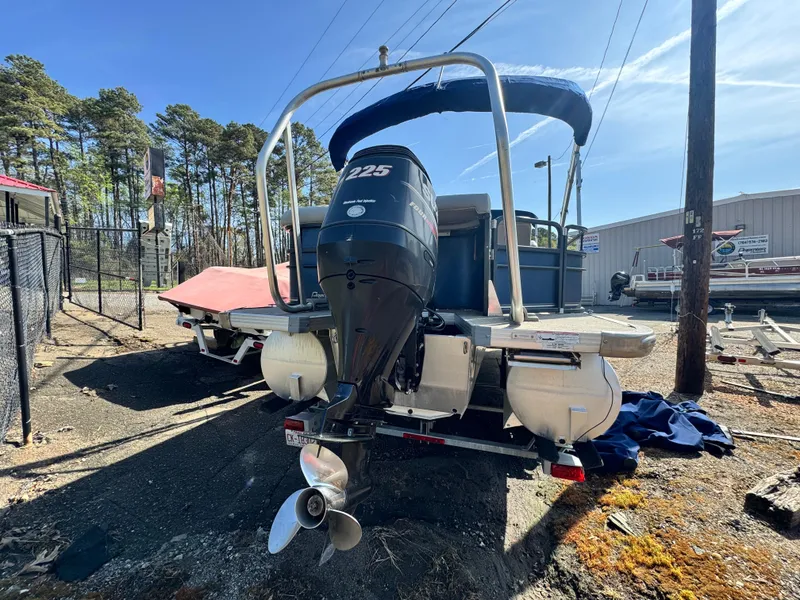 Slide: The Image of 2010 Premier 235 Grand Majestic LTD pontoon boat with 225 HP engine, docked outdoors. - 5