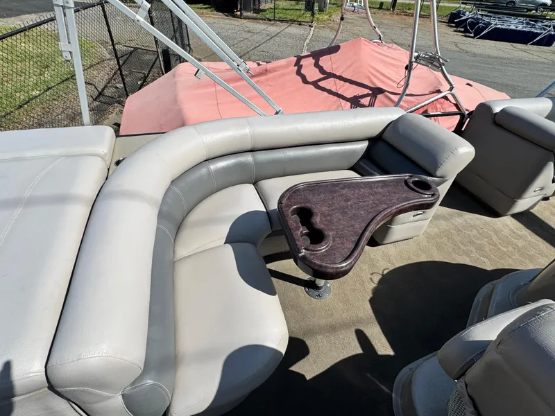 Slide: The Image of 2010 Premier 235 Grand Majestic LTD boat interior with curved seating and table. - 9