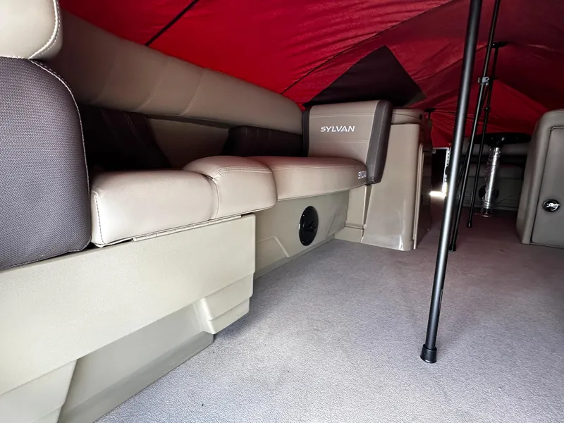 Slide: The Image of 2025 Sylvan Mirage 820 Cruise interior with beige seating and red canopy. - 3