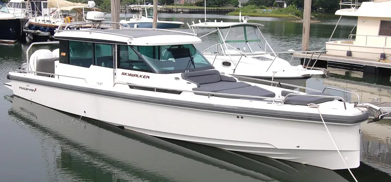 The Image of 2019 Axopar 37 SC boat docked in a marina, featuring sleek design and modern amenities. - 1