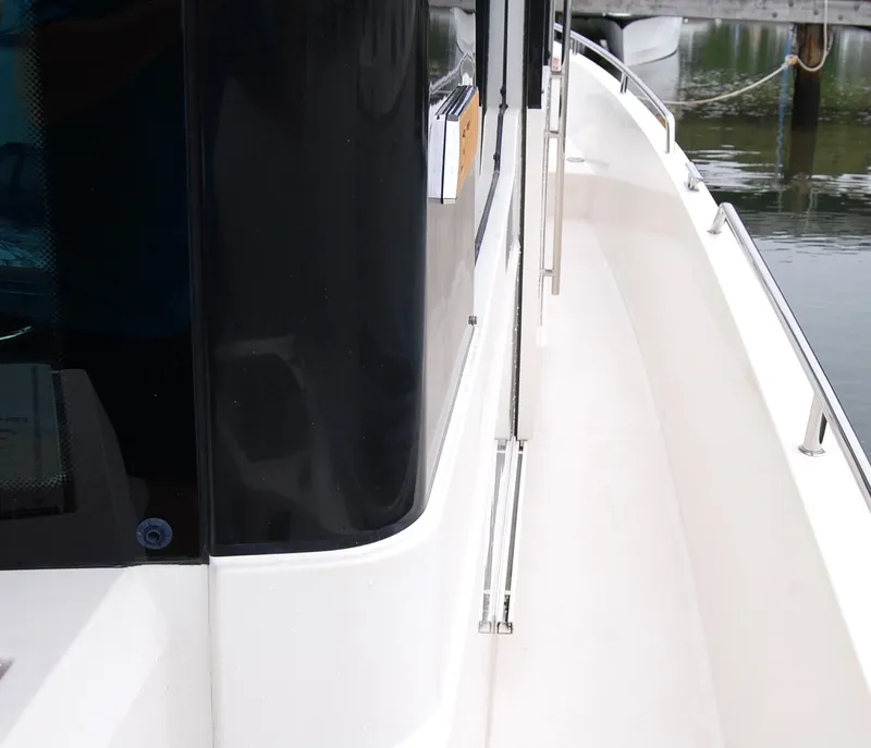 Slide: The Image of Side view of a 2019 Axopar 37 SC boat docked by the water. - 11
