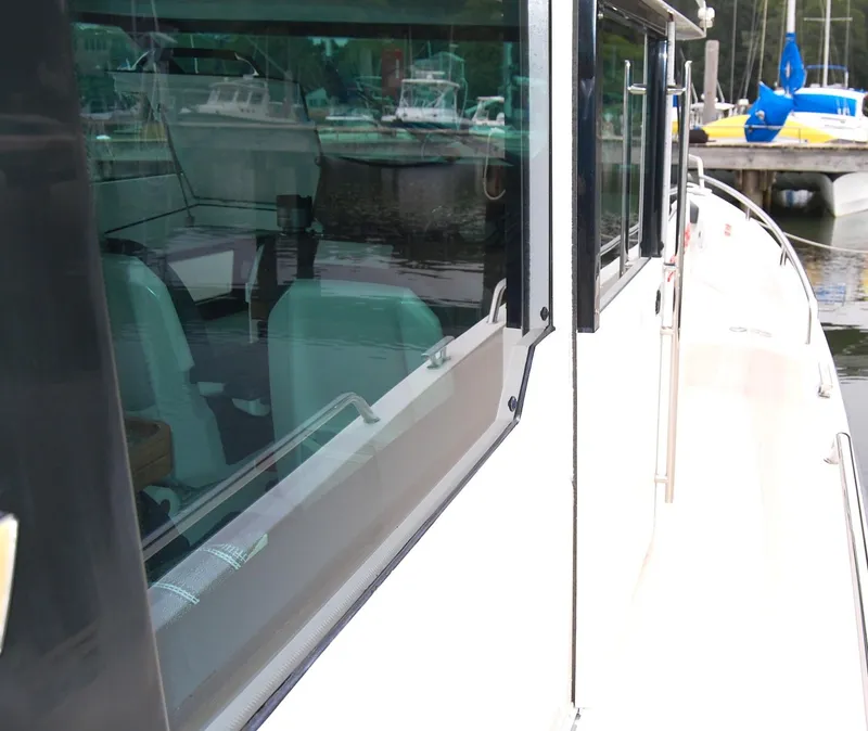 Slide: The Image of 2019 Axopar 37 SC boat docked, showcasing sleek design and windows. - 12