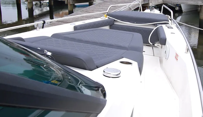 Slide: The Image of 2019 Axopar 37 SC boat with cushioned deck, docked at marina. - 13