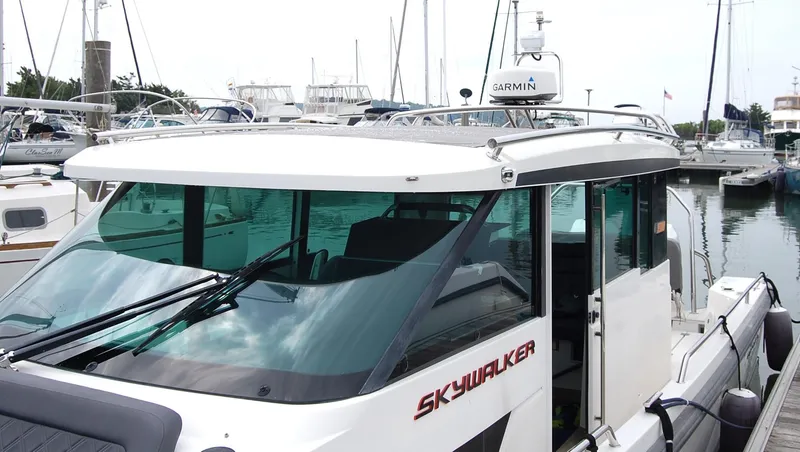 Slide: The Image of 2019 Axopar 37 SC boat docked in a marina, featuring sleek design and Garmin equipment. - 14