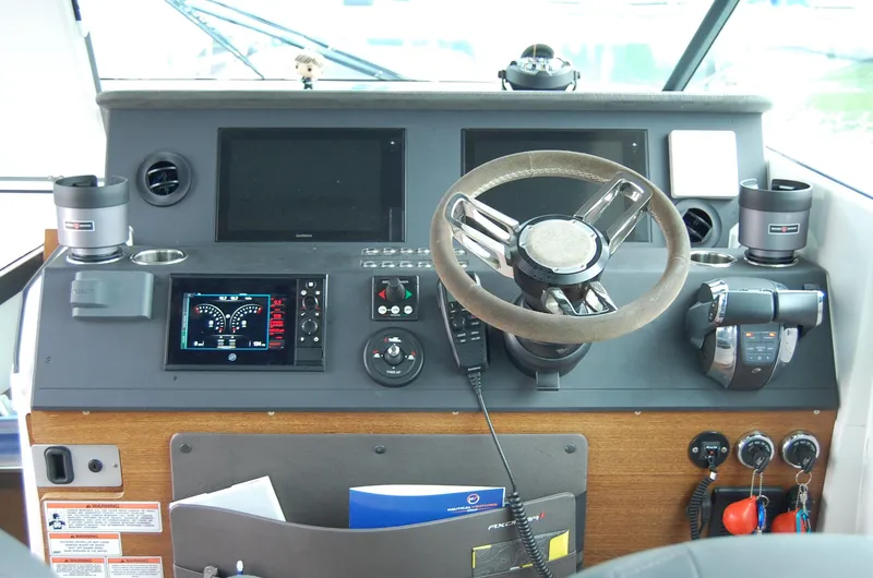 Slide: The Image of Control panel of a 2019 Axopar 37 SC boat with steering wheel and navigation displays. - 15