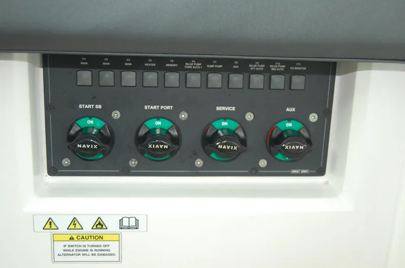 Slide: The Image of Control panel of 2019 Axopar 37 SC boat with labeled switches and caution sign. - 17