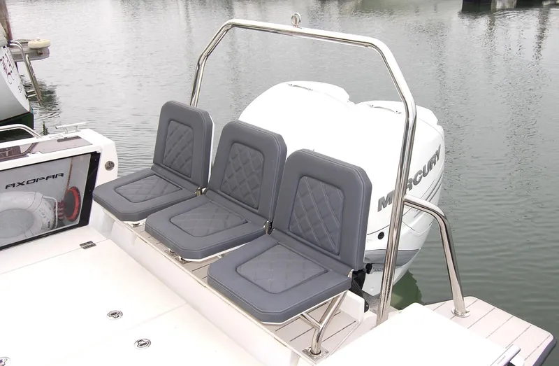 Slide: The Image of Three gray seats on a 2019 Axopar 37 SC boat, near water. - 4