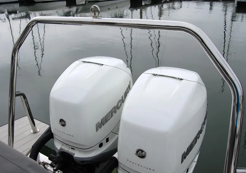 Slide: The Image of Twin Mercury outboard engines on a 2019 Axopar 37 SC boat at a marina. - 8