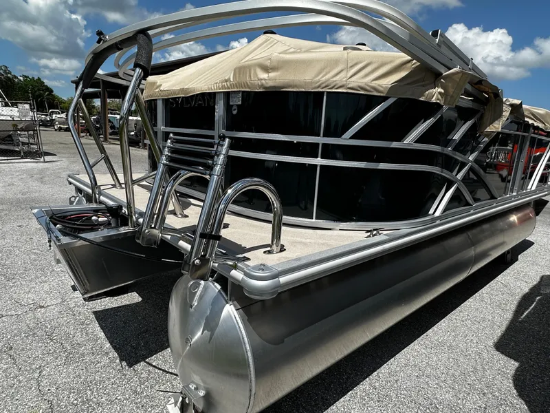 Slide: The Image of 2025 Sylvan Mirage 8520 LZ pontoon boat with sleek design and beige canopy. - 3