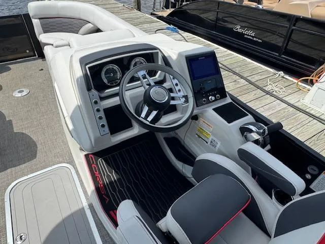 Slide: The Image of 2023 Barletta CORSA 23 UA boat interior with steering wheel and dashboard controls. - 18
