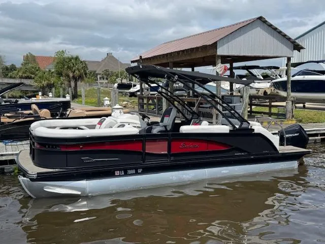 Slide: The Image of 2023 Barletta CORSA 23 UA pontoon boat docked at marina. - 2