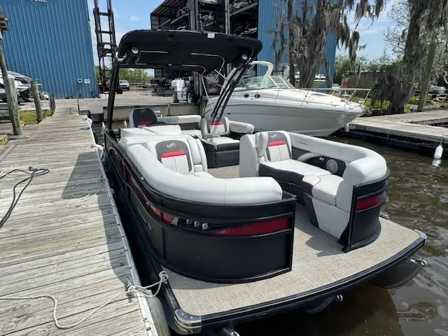 Slide: The Image of 2023 Barletta CORSA 23 UA pontoon boat docked, featuring sleek design and spacious seating. - 6
