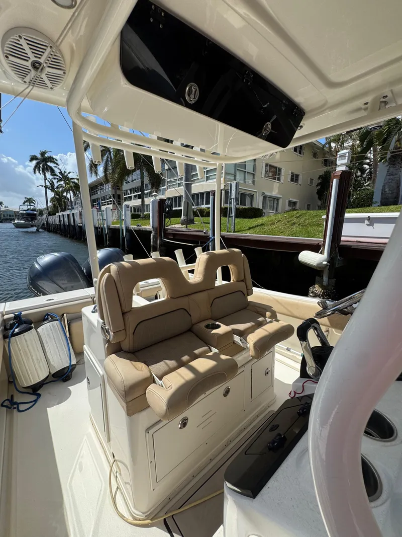 Slide: The Image of 2018 Key West Billistic 281 Center Console boat interior with seating and waterfront view. - 15