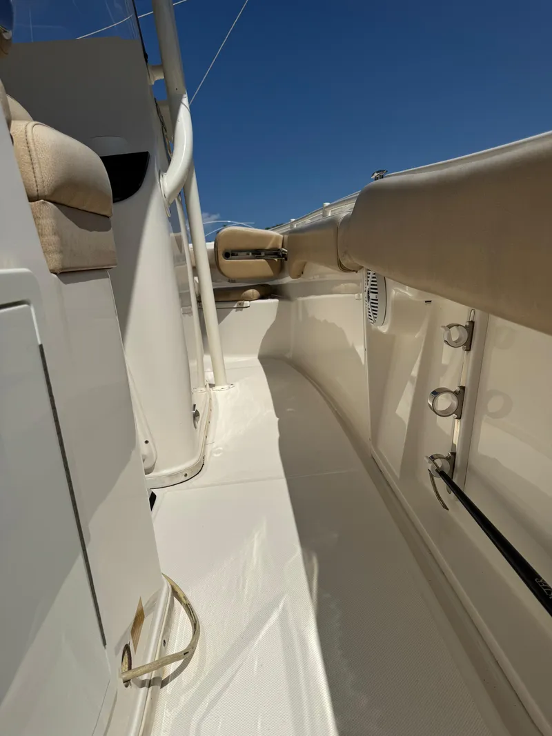 Slide: The Image of 2018 Key West Billistic 281 Center Console interior with beige seating and white deck. - 17