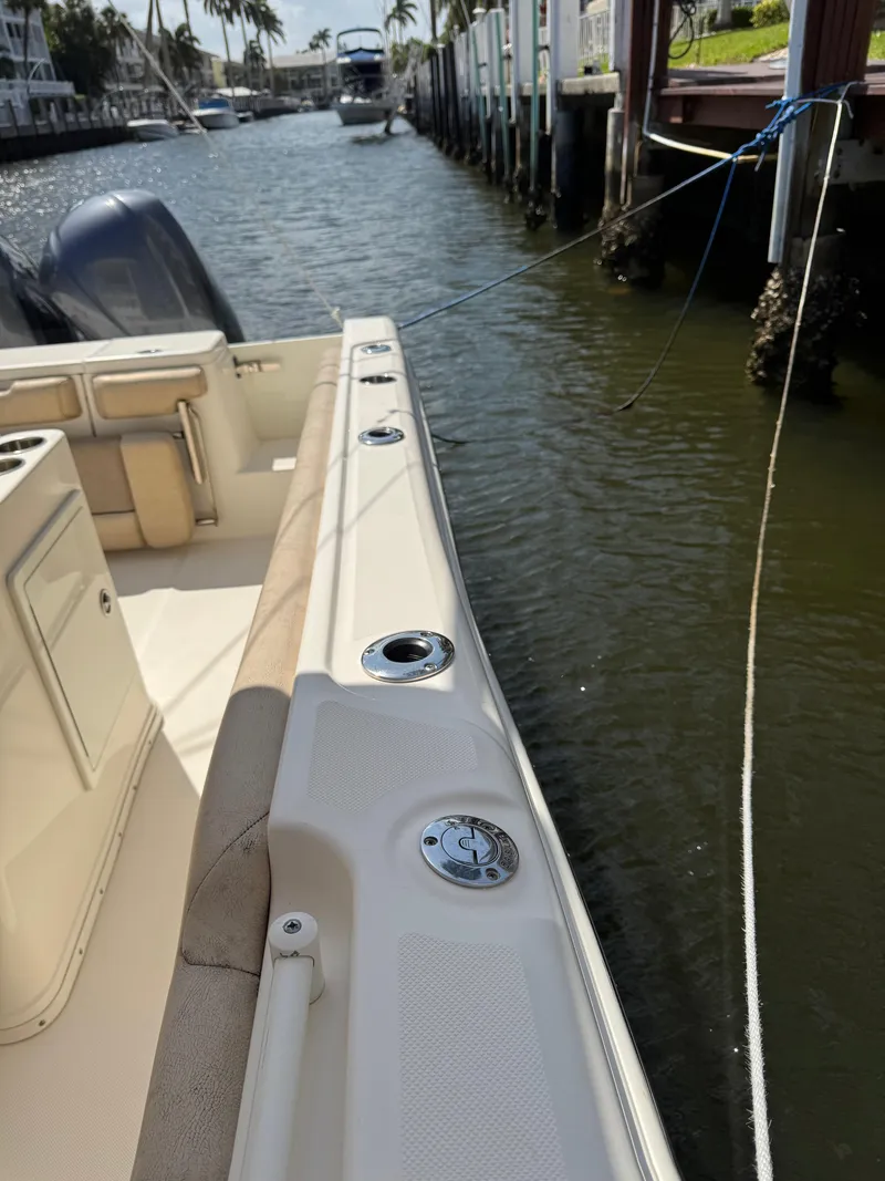 Slide: The Image of 2018 Key West Billistic 281 Center Console docked in a canal, sunny day. - 19
