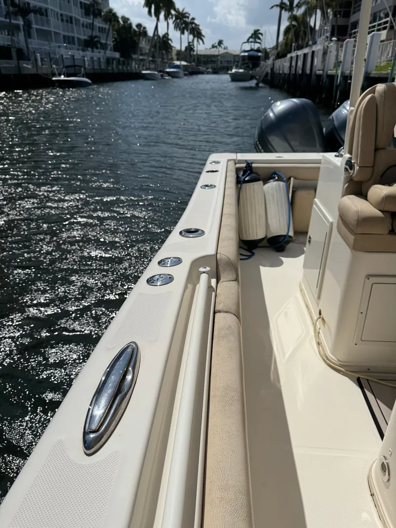 Slide: The Image of 2018 Key West Billistic 281 Center Console boat docked on a sunny canal. - 20