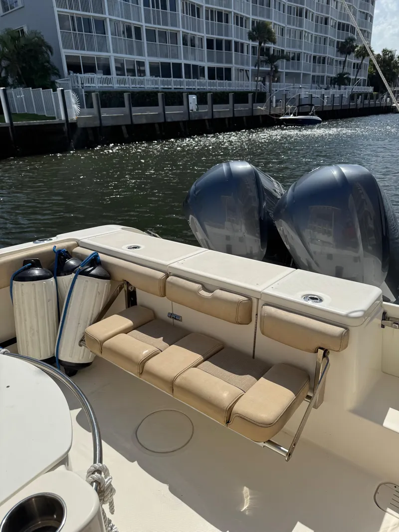 Slide: The Image of 2018 Key West Billistic 281 Center Console boat with dual engines docked by waterfront buildings. - 28