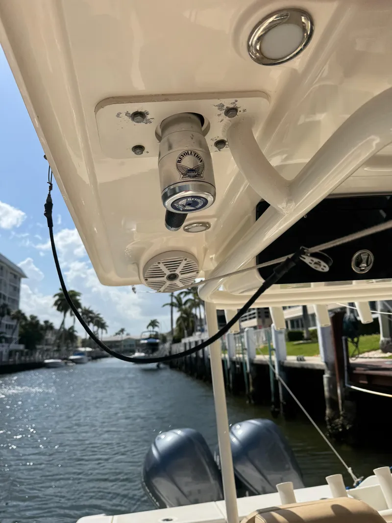 Slide: The Image of 2018 Key West Billistic 281 Center Console boat with mounted speakers and lights, docked by a canal. - 38