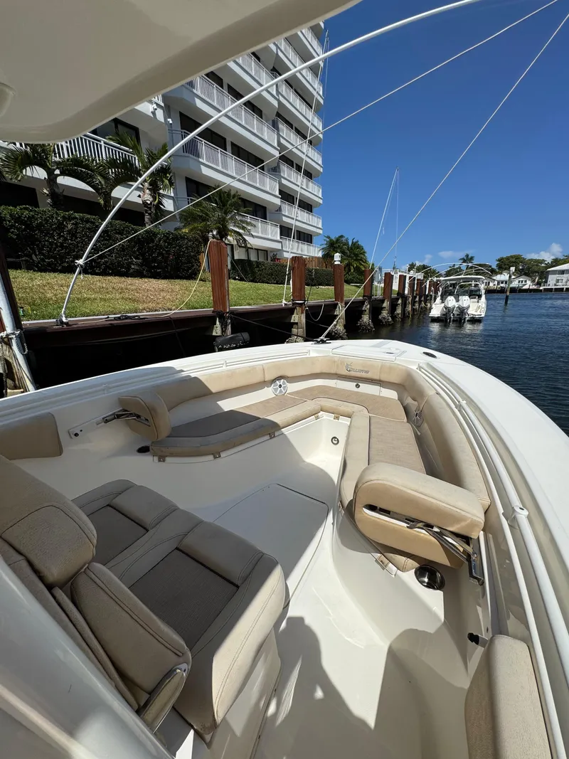 Slide: The Image of 2018 Key West Billistic 281 Center Console docked near waterfront buildings. - 6