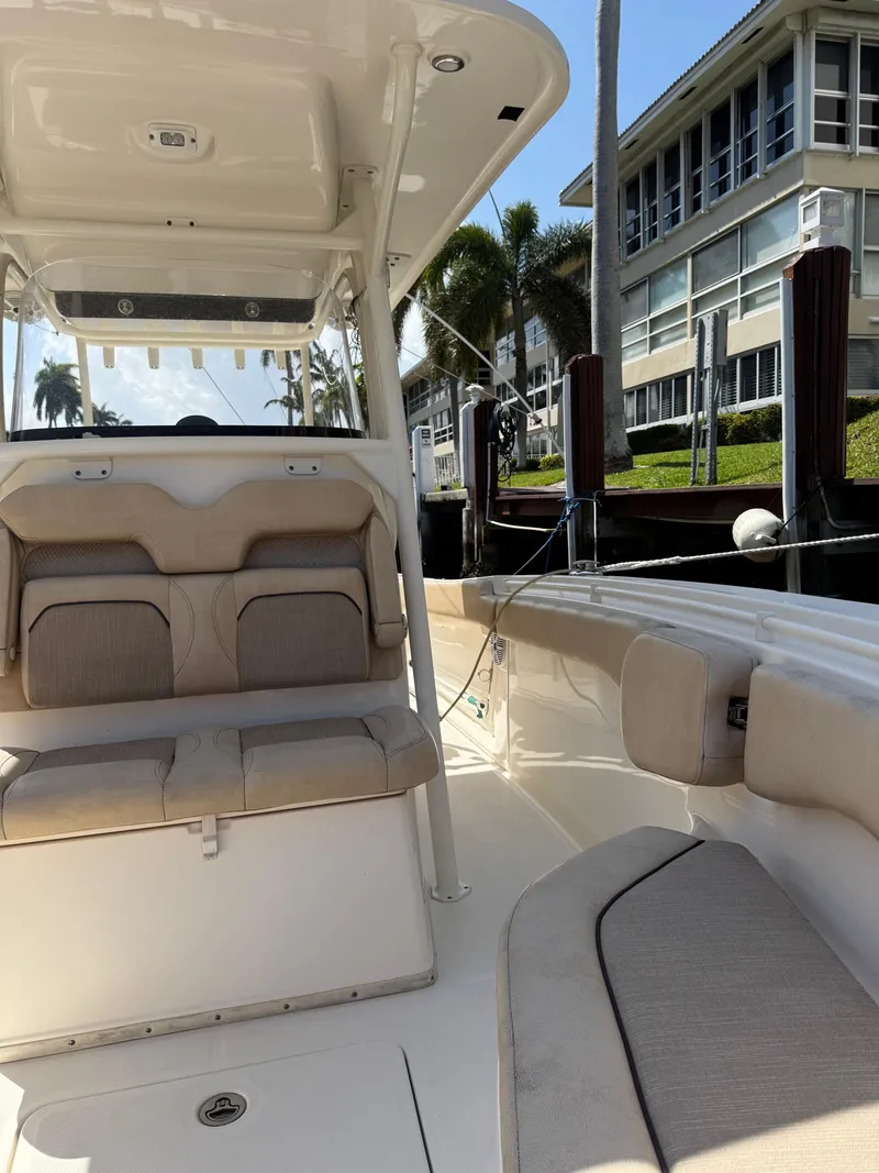 Slide: The Image of 2018 Key West Billistic 281 Center Console boat docked near waterfront homes. - 7