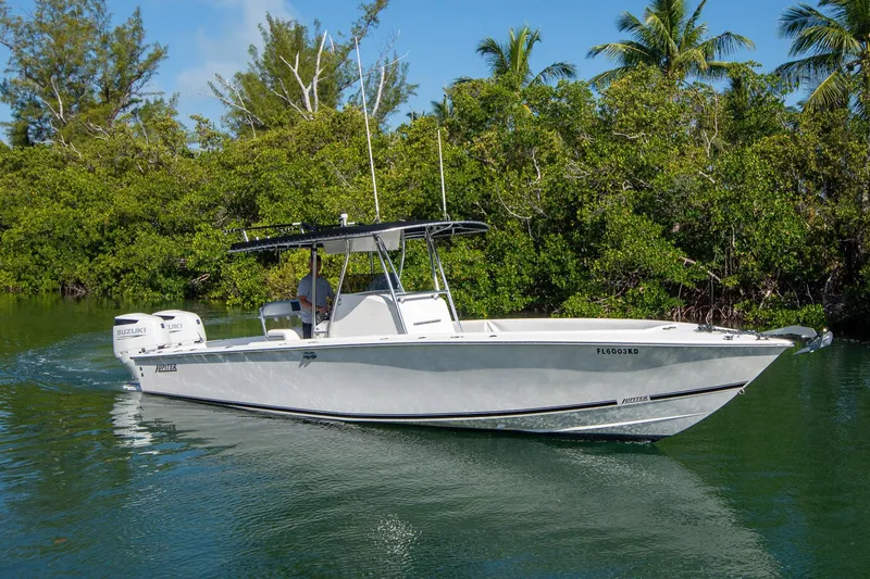 Slide: The Image of 1997 Jupiter 31 Open boat cruising on a calm waterway, surrounded by lush greenery. - 1