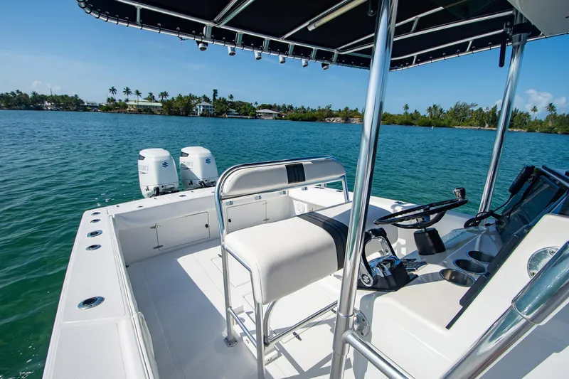 Slide: The Image of 1997 Jupiter 31 Open boat on calm water, featuring dual engines and sleek design. - 12