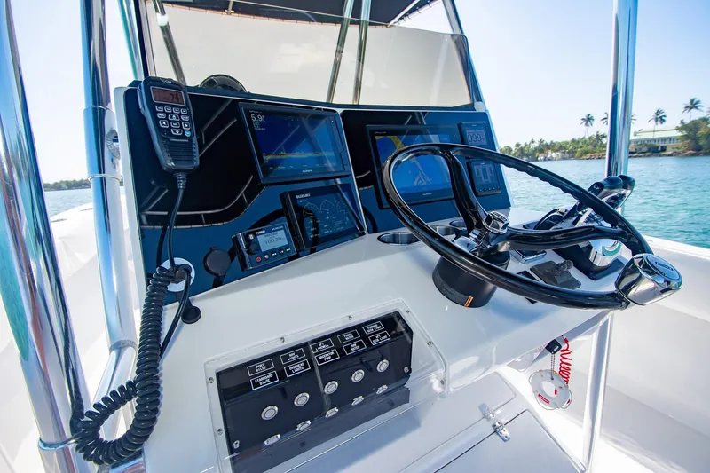Slide: The Image of Control panel of a 1997 Jupiter 31 Open boat with steering wheel and navigation equipment. - 16