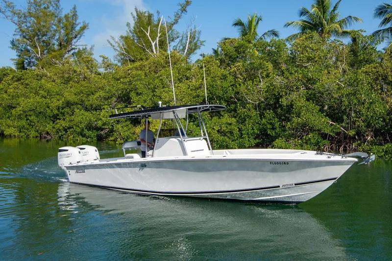 Slide: The Image of 1997 Jupiter 31 Open boat cruising on a calm waterway, surrounded by lush greenery. - 2