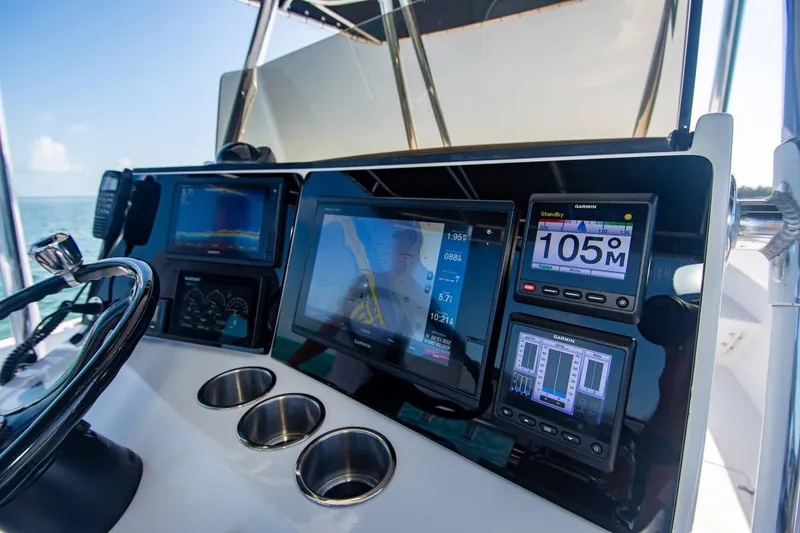 Slide: The Image of Control panel of a 1997 Jupiter 31 Open boat with navigation displays. - 29