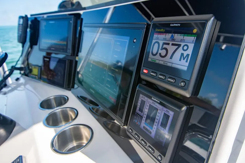 Slide: The Image of Control panel of a 1997 Jupiter 31 Open boat with Garmin navigation displays. - 31