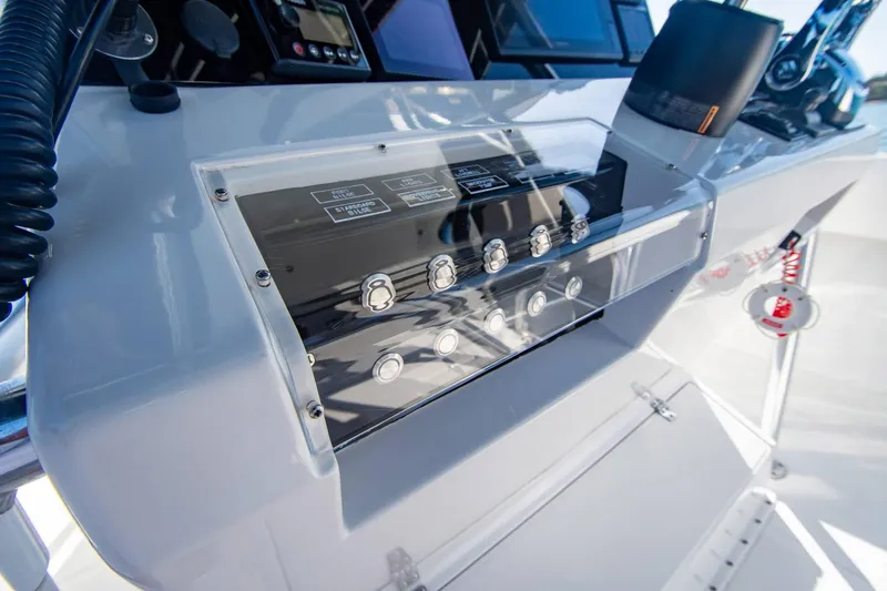 Slide: The Image of Control panel of a 1997 Jupiter 31 Open boat, featuring switches and displays. - 33
