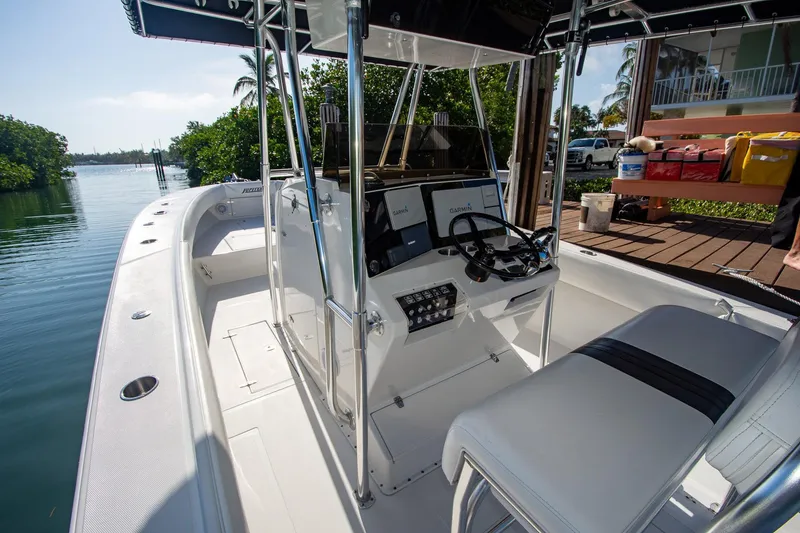 Slide: The Image of 1997 Jupiter 31 Open boat with sleek console, docked by a serene waterfront. - 36