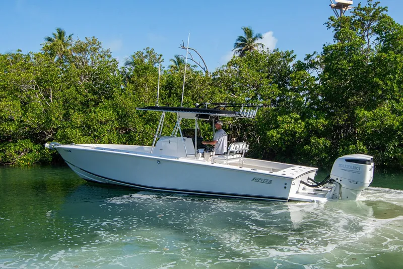 Slide: The Image of 1997 Jupiter 31 Open boat cruising in a lush, tropical waterway. - 4